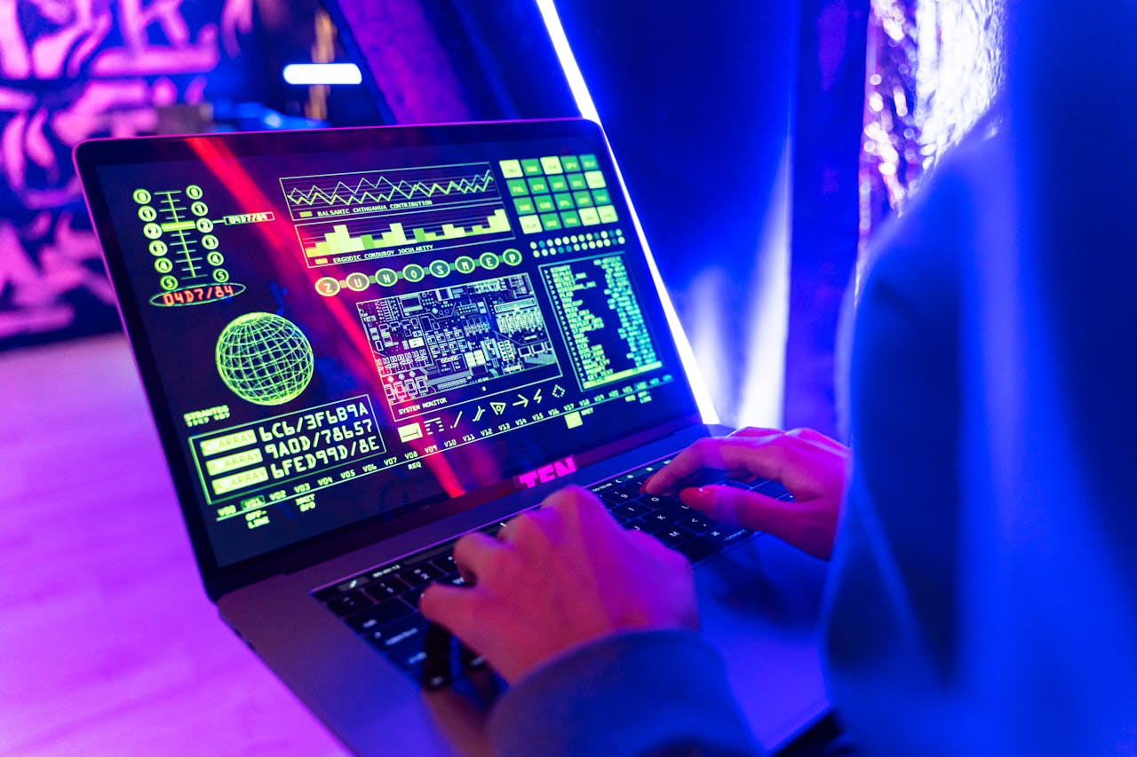 Services-03 Person typing on a laptop with vibrant digital data display, highlighting cyber security.